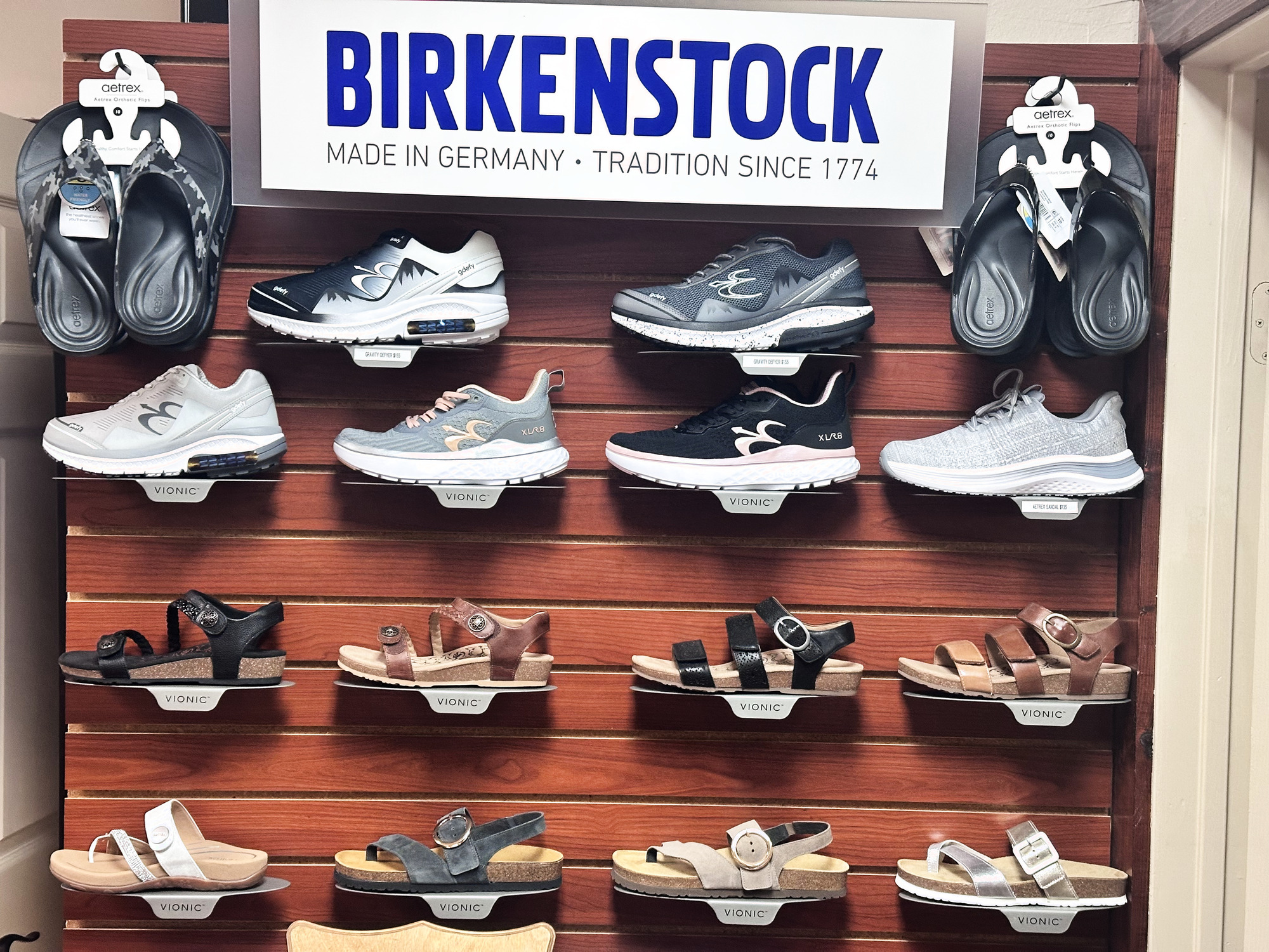 Birkenstock, Vionic, Aetrex and Gravity Defyer footwear curated on the Footsmart RX showroom wall
